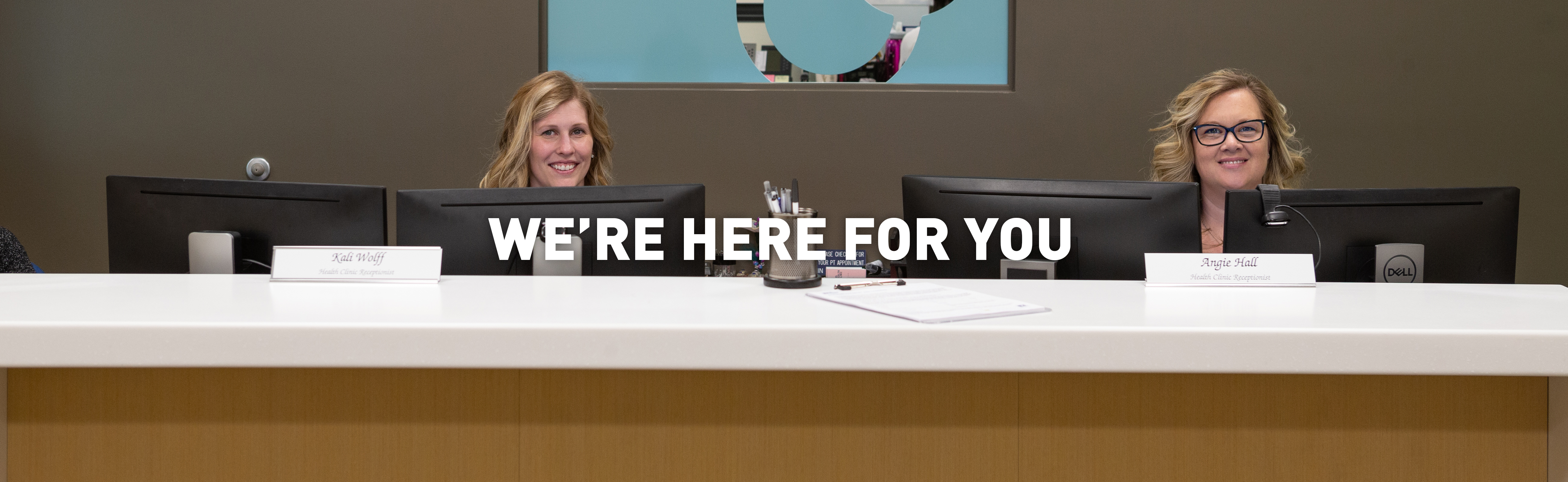 staff members standing behind reception